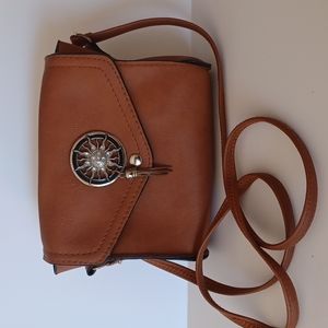 Leather brown purse with sun embellishment 10 " shortest X 21 " longest strap